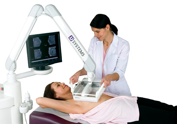 Female technologist performing 3D breast ultrasound on female patient